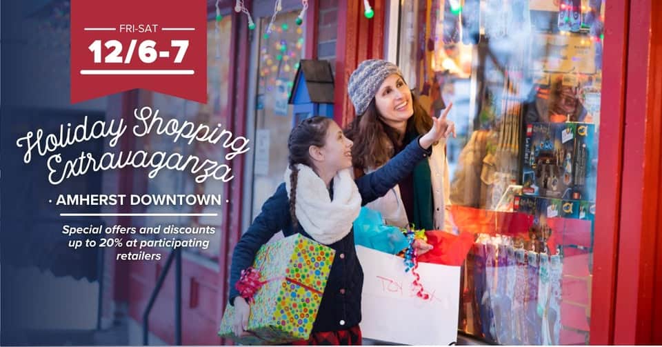 Christmas Markets Massachusetts 2025: Best Festive Events and Holiday Fairs 8 Two women and a girl carrying shopping bags look at a decorated store window during a holiday shopping event in downtown Amherst. Event dates and discount offers are displayed on the image.