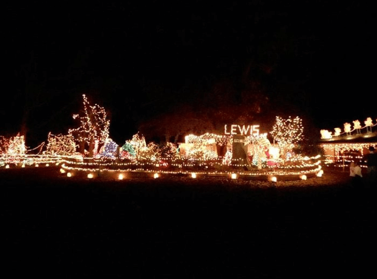 10 Jaw-Dropping Christmas Light Displays in Mississippi You Can’t Miss in 2025! 1 A house and yard are decorated with numerous Christmas lights at night, with the word "LEWIS" spelled out in white lights above the display.