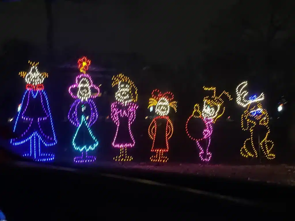 10 Dazzling Christmas Light Shows in Michigan You Can’t Miss in 2025 (Plus Free Spots & Secret Local Favorites!) 2 Six colorful light displays depict characters from Dr. Seuss’s “How the Grinch Stole Christmas” against a dark outdoor background.