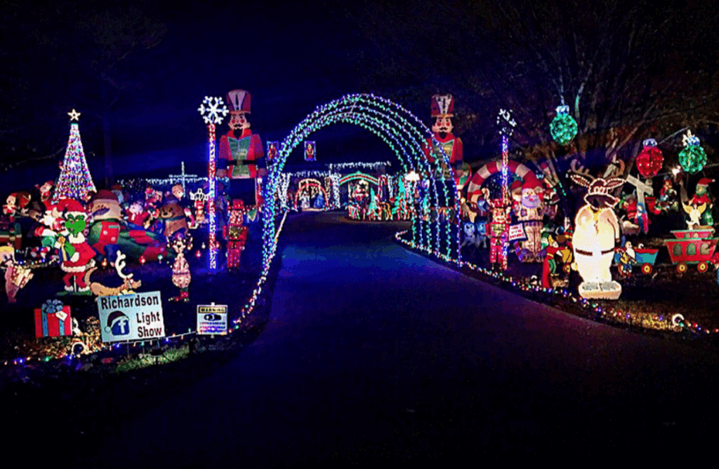 10 Jaw-Dropping Christmas Light Displays in Mississippi You Can’t Miss in 2025! 3 A driveway decorated with colorful Christmas lights, arches, and festive holiday figures, including snowmen, toy soldiers, and a Christmas tree at night.