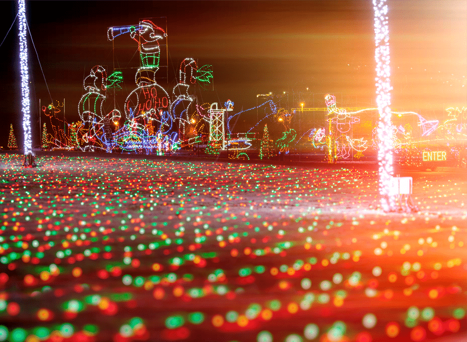 You won't Want To Miss Tennessee’s Most Magical Christmas Markets and Holiday Fairs for 2025 6 Colorful holiday light display featuring a large illuminated Santa Claus, candy canes, and festive decorations, with glowing red and green lights on the ground.