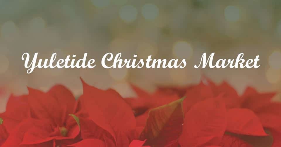 You won't Want To Miss Tennessee’s Most Magical Christmas Markets and Holiday Fairs for 2025 9 White text reading "Yuletide Christmas Market" appears over a blurred background with red poinsettia flowers at the bottom.