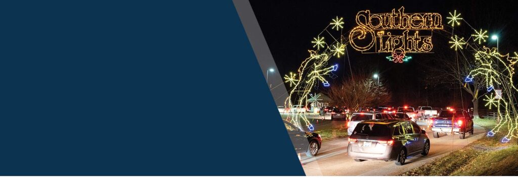Discover Kentucky’s Jaw-Dropping Christmas Light Spectacles That Will Leave You Breathless This Holiday Season 9 Cars drive through a holiday light display at night, with an illuminated sign reading "Southern Lights" arching over the entrance.
