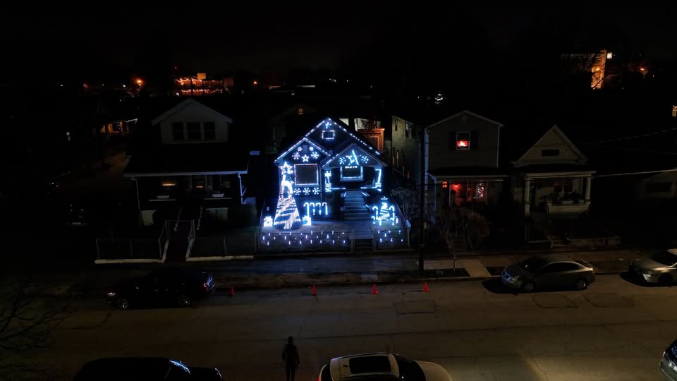 Discover Kentucky’s Jaw-Dropping Christmas Light Spectacles That Will Leave You Breathless This Holiday Season 7 A house decorated with bright white Christmas lights, including candy canes and snowflakes, stands out on a dark residential street at night.