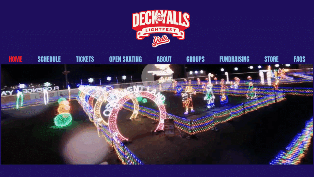 Discover Kentucky’s Jaw-Dropping Christmas Light Spectacles That Will Leave You Breathless This Holiday Season 4 A festive outdoor light display with colorful illuminated arches and decorations for Deck the Yalls Lightfest, shown on a dark purple website background.