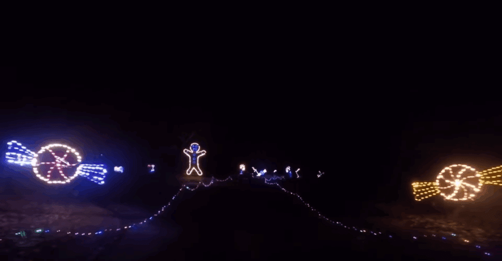 Massachusetts’ Most Magical Christmas Light Displays That Families Can’t Stop Talking About in 2025 6 A nighttime scene with a road lined by illuminated holiday decorations, including candy shapes and a gingerbread figure made of colorful lights.