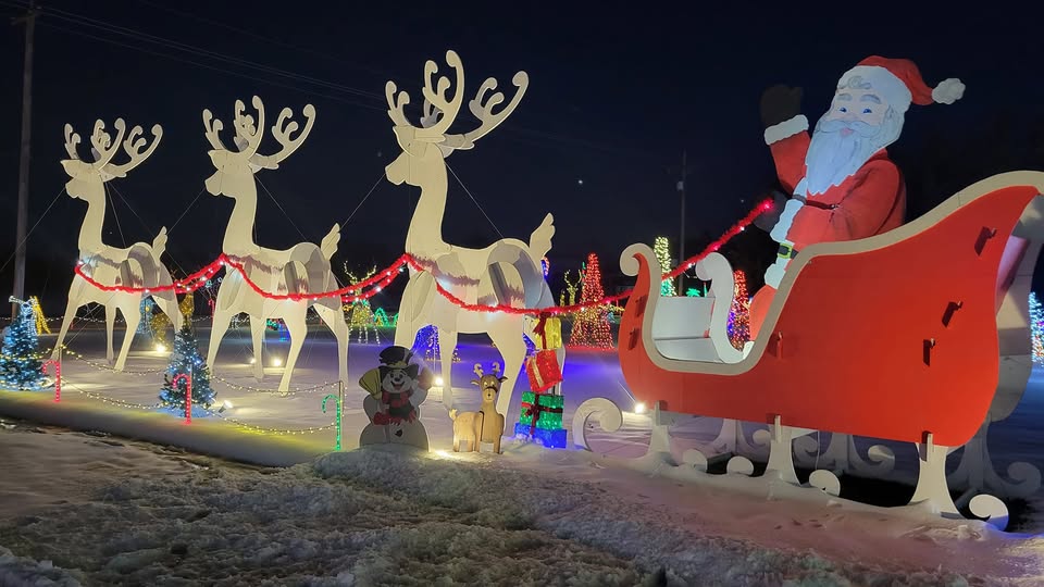 Kansas Christmas Light Shows 2025: The Ultimate Guide to the Most Stunning Holiday Displays You Can’t Miss! 4 Outdoor Christmas display featuring Santa Claus in a red sleigh with three large white reindeer, festive lights, snow, and holiday decorations at night.