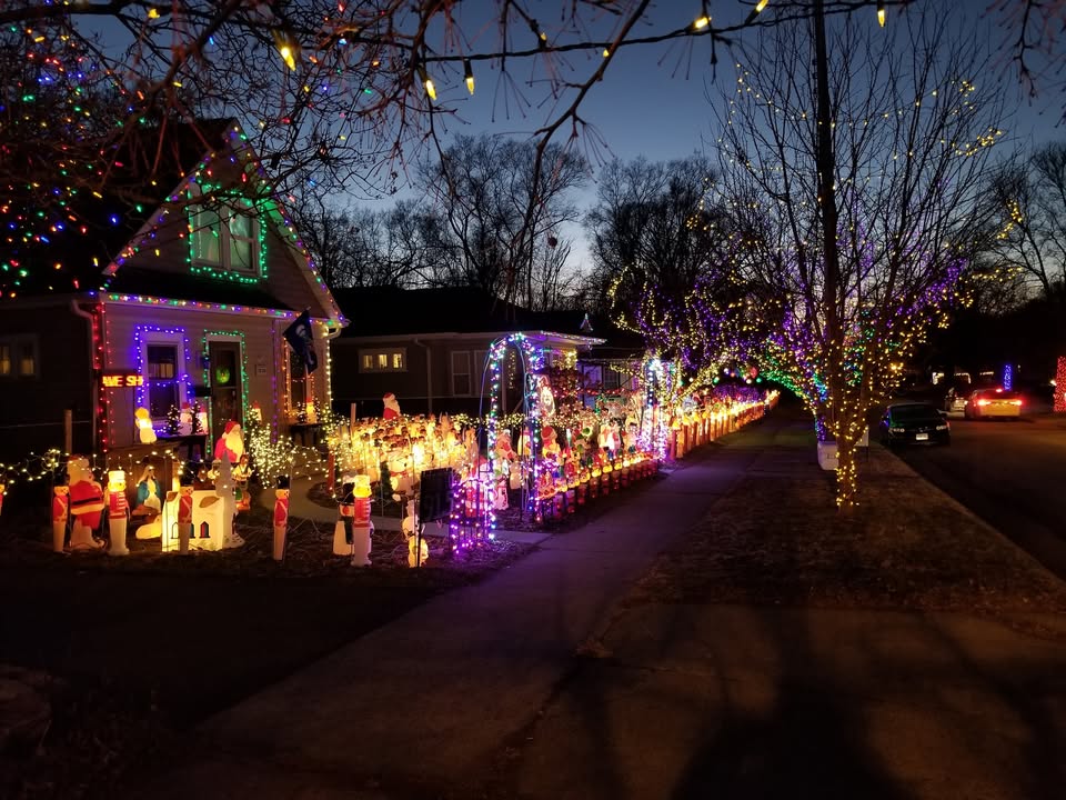 Minnesota’s Top 5 Unmissable Christmas Light Shows for 2025—Discover Hidden Gems and Festive Magic Near You! 2 A residential street is decorated with numerous colorful Christmas lights and holiday figures at dusk, with illuminated trees and houses lining the road.