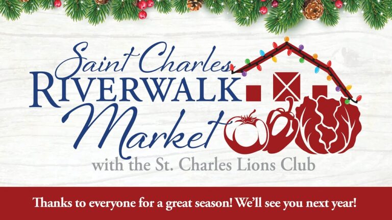 Saint Charles Riverwalk Market holiday-themed sign with produce icons, barn graphic, and message thanking visitors for a great season from the St. Charles Lions Club.